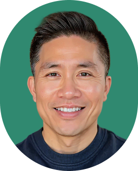 A smiling man with short, styled dark hair and wearing a dark crew-neck top, shown against a solid green background.