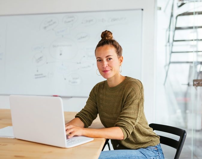 woman working with laptop in a meeting room.