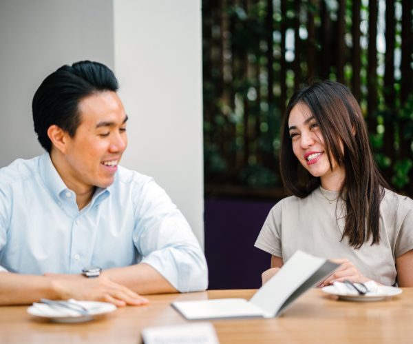 man and woman discussing obligation management in business meeting