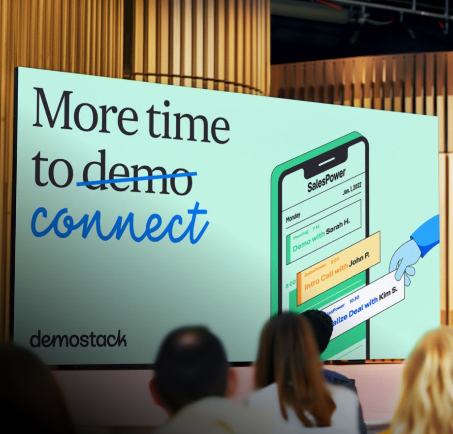 A presentation screen displays the text More time to connect with demo crossed out, next to an illustration of a smartphone calendar, in front of an audience. The logo demostack is visible in the corner.