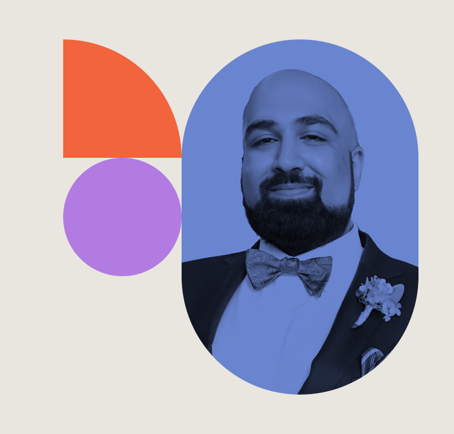 A man in a suit with a bow tie and boutonniere smiles at the camera. The image is tinted blue and framed by an oval, next to red and purple geometric shapes on a light background.